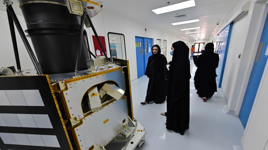 Engineers gather in front of a KhalifaSat model at the Mohammed Bin Rashid Space Centre (MBRSC), in the Gulf emirate of Dubai on July 5, 2020. - The oil-rich United Arab Emirates has built a nuclear power programme and sent a man to space, and now plans to join another elite club by sending a probe to Mars.
Only the United States, India, the former Soviet Union, and the European Space Agency have successfully sent missions to orbit the Red Planet, while China is preparing to launch its first Mars rover late