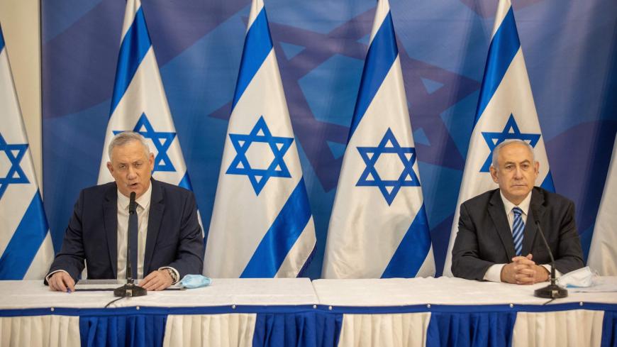 Israeli Prime Minister Benjamin Netanyahu (R) and alternate Prime Minister and Defence Minister Benny Gantz (L) issue a statement at the Israeli Defence Ministry in Tel Aviv on  July 27, 2020 following the high tensions with the Lebanese militant group Hezbollah at the Israeli-Lebanon border. (Photo by Tal SHAHAR / POOL / AFP) (Photo by TAL SHAHAR/POOL/AFP via Getty Images)