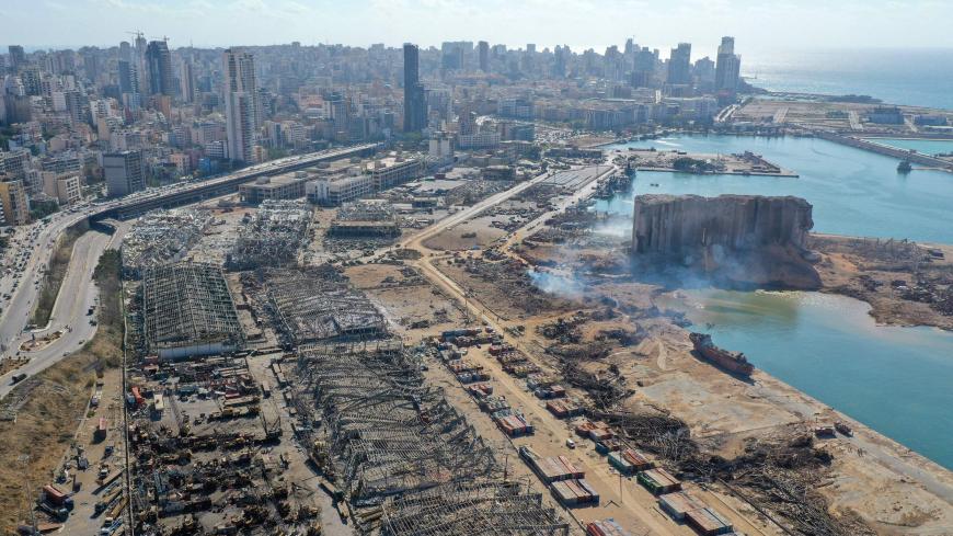 An aerial view shows the massive damage done to Beirut port's grain silos (C) and the area around it on August 5, 2020, one day after a mega-blast tore through the harbour in the heart of the Lebanese capital with the force of an earthquake, killing more than 100 people and injuring over 4,000. - Rescuers searched for survivors in Beirut in the morning after a cataclysmic explosion at the port sowed devastation across entire neighbourhoods, killing more than 100 people, wounding thousands and plunging Leban