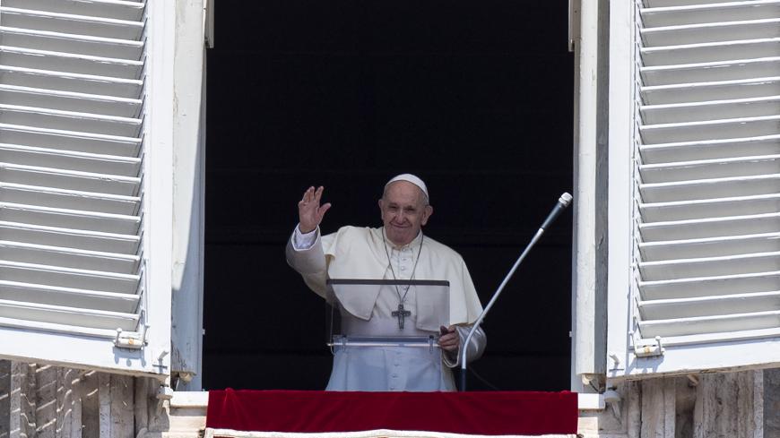 Pope Francis waves at faithfuls from the window of the apostolic palace overlooking St.Peter's square during his Angelus prayer on August 15, 2020 at the Vatican. (Photo by Tiziana FABI / AFP) (Photo by TIZIANA FABI/AFP via Getty Images)