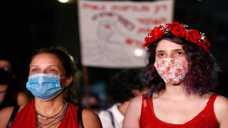 Israeli protesters, wearing protective masks due to the COVID-19 pandemic, hold placards as they take part in a demonstration in Tel Aviv on August 23, 2020, to denounce sexual violence against women following the alleged gang-rape of a 16-year-old girl in a Red Sea resort. - Police said 11 suspects, including nine minors and a woman said to be the manager of the hotel in which the alleged rape took place, had been arrested in connection with the affair so far as part of an "ongoing investigation". (Photo b