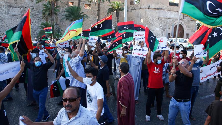 Libyans chant slogans during a demonstration due to poor public services at the Martyrs' Square at the centre of the GNA-held Libyan capital Tripoli on August 25, 2020. - Angered by chronic water, power, and petrol shortages in a country with Africa's largest proven crude oil reserves, the mostly young people had marched through the city centre chanting slogans including "No to corruption!" (Photo by - / AFP) (Photo by -/AFP via Getty Images)
