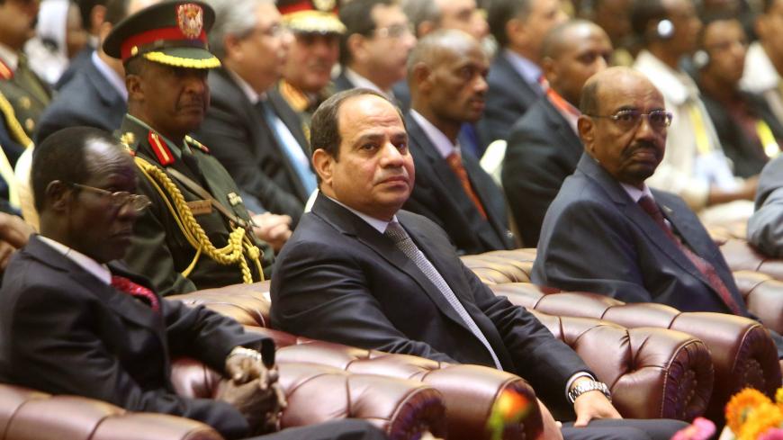 South Sudan's Vice President James Wani Igga (L), Egyptian President Abdel-Fattah al-Sisi (C) and Sudanese President Omar al-Bashir attend a meeting in the Sudanese capital Khartoum on March 23, 2015 to sign the agreement of principles on Ethiopia's Grand Renaissance dam project. Egypt agreed to a preliminary deal with Ethiopia on a new dam project that Cairo feared would hamper the flow of the Nile, the river on which it depends. AFP PHOTO / ASHRAF SHAZLY        (Photo credit should read ASHRAF SHAZLY/AFP 