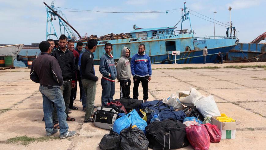 Egyptian fishermen, who had entered the Libyan waters with out permission, gather at the port in the Libyan city of Misrata on April 2, 2015, following the order of their release after three months in detention. A Libyan maritime official said the release came after coordinating with their families and Egyptian authorities. AFP PHOTO / MAHMUD TURKIA        (Photo credit should read MAHMUD TURKIA/AFP via Getty Images)