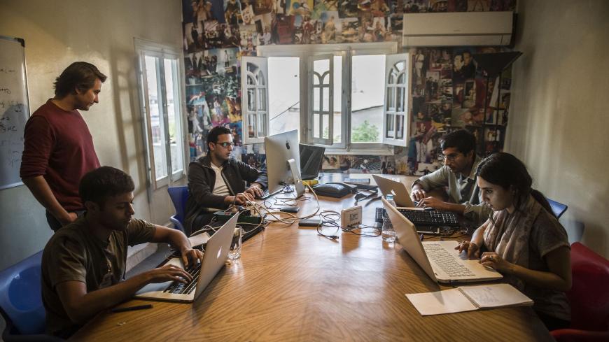 Menna Ayman, Salem Massalha, Shehab el-Dien, Alban Menonville, and Nader Meleika members of the Egyptian startup business, Bassita, work at their office in Cairo on April 12, 2016. 

Bassita, which means "simple" in Arabic, is harnessing the growing Internet penetration in the country and raising funds through social networking campaigns. It posts photos and videos of micro-development projects, and sponsors undertake the funding once a certain number of shares and "likes" are raised.

 / AFP / KHALED DESOU