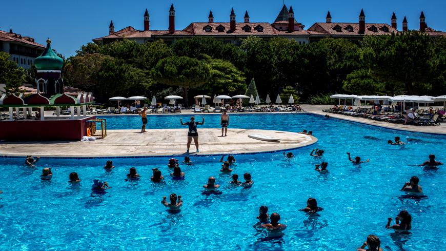 ANTALYA, TURKEY - JULY 12: Tourists take part in an aqua aerobics session at an all inclusive Russian themed resort on July 12, 2016 in Antalya, Turkey. Russian President Vladimir Putin last month officially lifted travel restrictions on tourism to Turkey. Russia had banned agency tours to Turkey after a diplomatic crisis erupted when Turkey downed a Russian jet on the Turkey - Syrian border in November 2015.  Turkey's tourism is currently in crisis after a series of terrorist attacks, most recently the bom