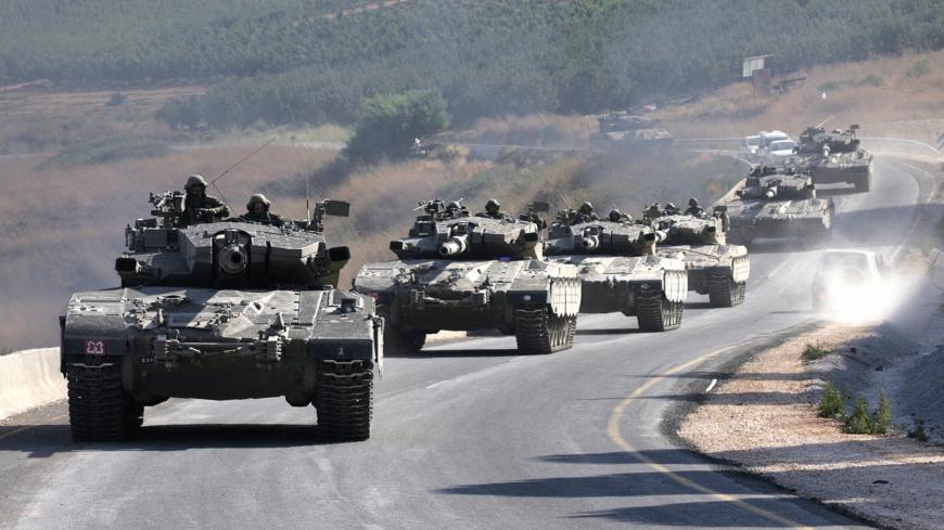 Israel-Lebanon Border, ISRAEL:  Israeli tanks roll towards Israel-Lebanon border, 11 August 2006. Israeli Prime Minister Ehud Olmert ordered the army today to prepare for launching its expanded ground offensive in Lebanon after diplomatic efforts stumbled, a senior government official said. AFP PHOTO/DENIS SINYAKOV  (Photo credit should read DENIS SINYAKOV/AFP via Getty Images)