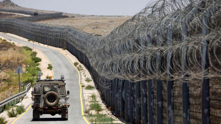 An Israeli army vehicle is seen driving along the road parallel to the border fence separating the Israeli-annexed Golan Heights and Syria, on July 19, 2017.
Israel is planning for a new field hospital to treat patients from the civil-war hit country, on the Syrian side of the fence but on the Israeli side of the demarcation line in the Golan Heights which it occupied in 1967, its military said on July 19, 2017.
 / AFP PHOTO / MENAHEM KAHANA        (Photo credit should read MENAHEM KAHANA/AFP via Getty Imag