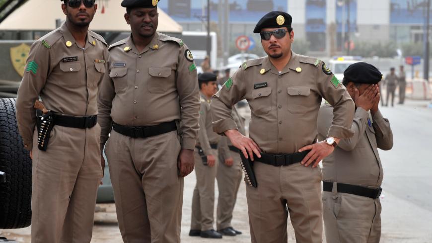 Saudi policemen stand guard in front of the "Public grievances Department" building in Riyadh on March 11, 2011 as Saudi Arabia launched a massive security operation in a menacing show of force to deter protesters from a planned "Day of Rage" to press for democratic reform in the kingdom.   AFP PHOTO/FAYEZ NURELDINE (Photo credit should read FAYEZ NURELDINE/AFP via Getty Images)