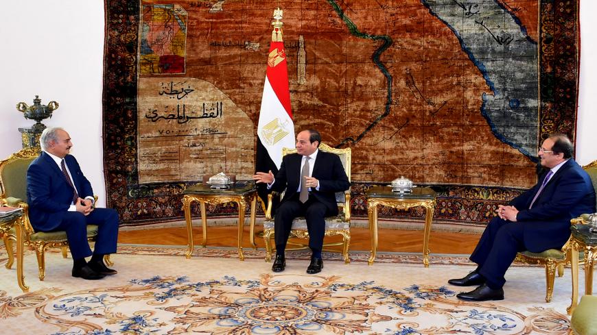 This handout picture released by the Egyptian Presidency on April 14, 2019, shows Egyptian president Abdel Fattah al-Sisi (C) and intelligence chief Abbas Kamel (R) meeting Libyan strongman Khalifa Haftar (L) at the Ittihadia presidential Palace in the capital Cairo. - Egyptian President Abdel Fattah al-Sisi met Sunday with Libyan commander Khalifa Haftar whose forces are fighting for control of the capital Tripoli, state media reported. Sisi has been an ardent supporter of Haftar's forces, which control sw