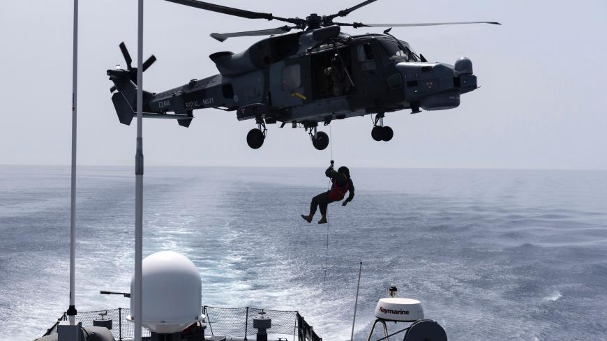 A picture taken from Cyprus' warship "Ioannides" shows a Royal Navy Lynx helicopter taking part in the "Multinational CIMIC Exercise, ARGONAUT 2019, Search and Rescue (SAR) Operations, a rescue drill in which the militaries of Cyprus, Greece, France, Britain, Israel, Germany and the US participated on May 30, 2019 off the coast of Mari between the southern ports of Larnaca and Limassol in the eastern Mediterranean island of Cyprus. (Photo by Iakovos Hatzistavrou / AFP)        (Photo credit should read IAKOV