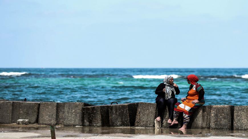 Two Egyptian women speak on a popular beach during summer vacations in the city of Alexandria, on August 01, 2019. (Photo by Mohamed el-Shahed / AFP)        (Photo credit should read MOHAMED EL-SHAHED/AFP via Getty Images)