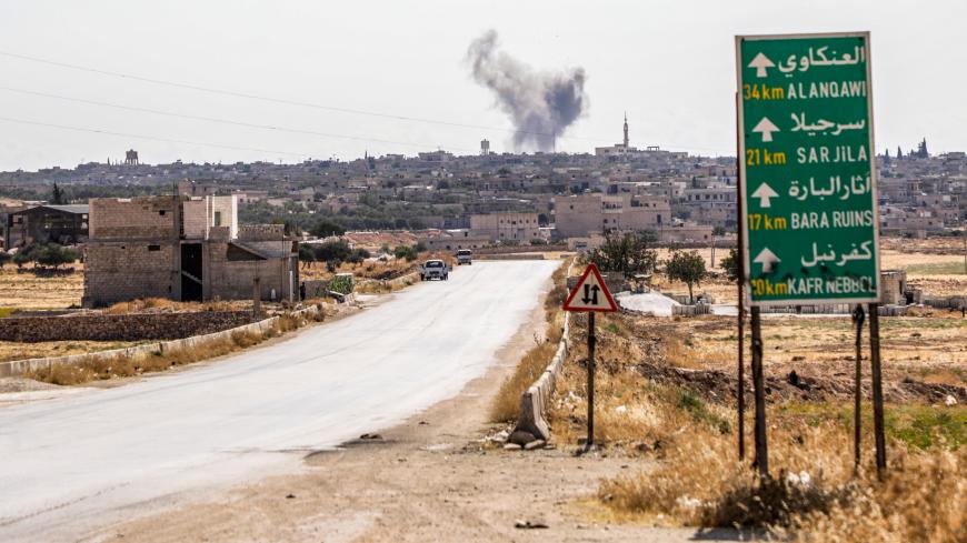 This picture taken on August 16, 2019 shows a smoke plume rising following a reported air strike in Kfar Ruma in Syria's northwestern Idlib province. - Air strikes on August 16 by Syria's regime and its Russian ally killed 15 civilians in the area controlled by Syria's former Al-Qaeda affiliate Hayat Tahrir al-Sham (HTS) in Idlib province, said the Britain-based Syrian Observatory for Human Rights. The strikes came as regime forces battled HTS jihadists and allied rebels in the region, where fierce fighting