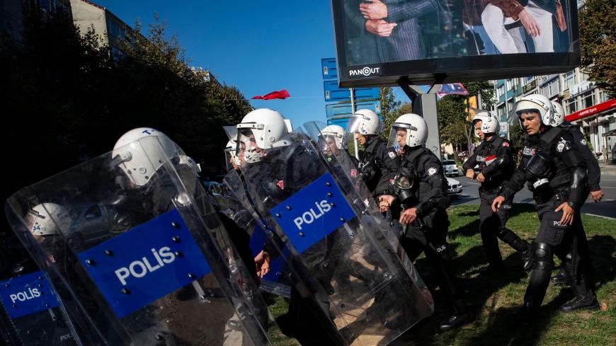 Turkish anti-riot police officers run as Kurds protest against Turkish military operation in Syria, in Istanbul, on October 13, 2019. - Fighting has engulfed the border area in northeastern Syria since Turkey launched an offensive on October 9 to push back the Kurdish-led Syrian Democratic Forces (SDF), displacing 130,000 people so far according to the United Nations, amidst warnings from aid groups of another humanitarian disaster in Syria's eight-year-old war if the offensive is not halted. (Photo by Yasi