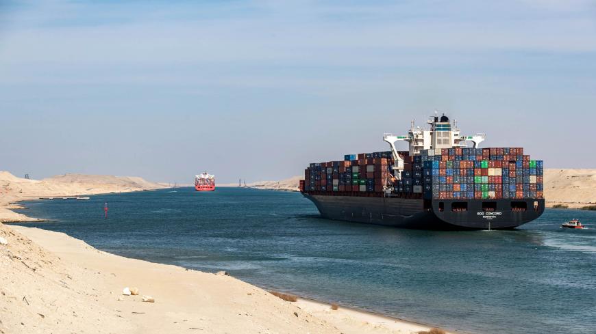 This picture taken on November 17, 2019 shows the Liberia-flagged container ship RDO Concord sailing through Egypt's Suez Canal in the canal's central hub city of Ismailia on the 150th anniversary of the canal's inauguration. - One hundred and fifty years after the Suez Canal opened, the international waterway is hugely significant to the economy of modern-day Egypt, which nationalised it in 1956. The canal, dug in the 19th century using "rudimentary tools" and which links the Mediterranean to the Red Sea, 