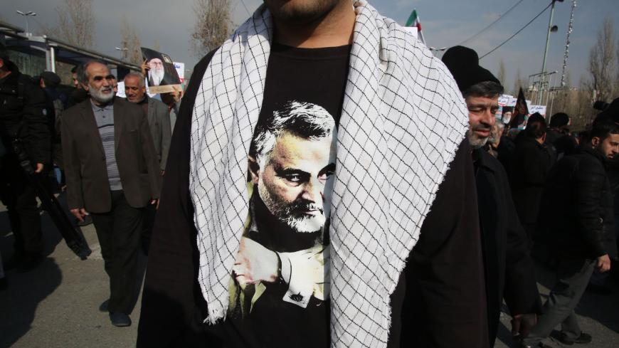 TOPSHOT - An Iranian, wearing a t-shirt with a picture of slain commander Qasem Soleimani, takes part in a demonstration in the capital Tehran on January 3, 2020 against the killing of the Iranian Revolutionary Guards top commander in a US strike in Baghdad. - Iran warned of "severe revenge" and said arch-enemy the United States bore responsiblity for the consequences after killing one of its top commanders, Qasem Soleimani, in a strike  outside Baghdad airport. (Photo by ATTA KENARE / AFP) (Photo by ATTA K
