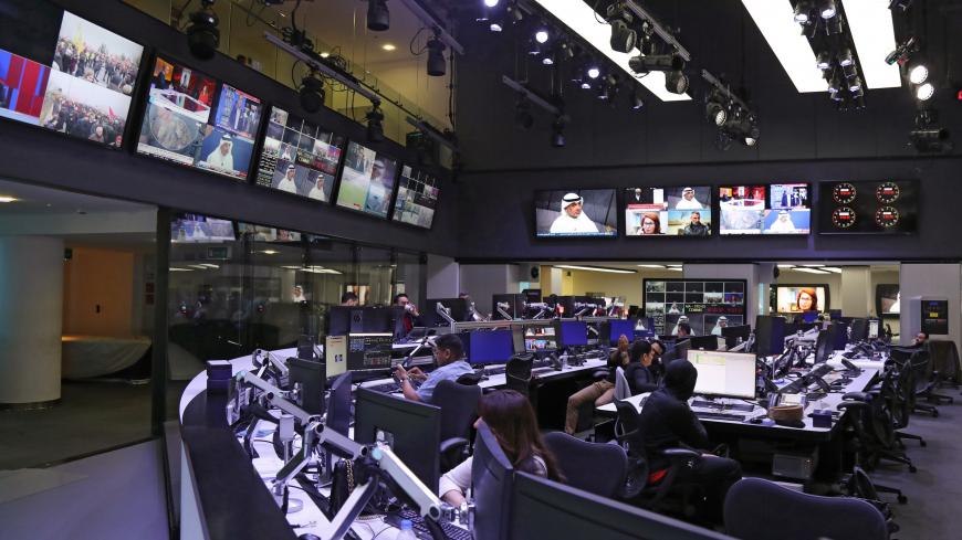 This picture taken on December 5, 2019, shows a general view of the newsroom at the headquarters of the Qatar-based al-Jazeera satellite news channel in the capital Doha. - Qatar-based broadcaster Al-Jazeera has travelled a long and bumpy road from the early 2000s when it was best known for airing tapes of former Al-Qaeda leader Osama bin Laden. It now cultivates a loyal youth audience on social media alongside the satellite channels which have won it both acclaim and scorn. (Photo by KARIM JAAFAR / AFP) (P