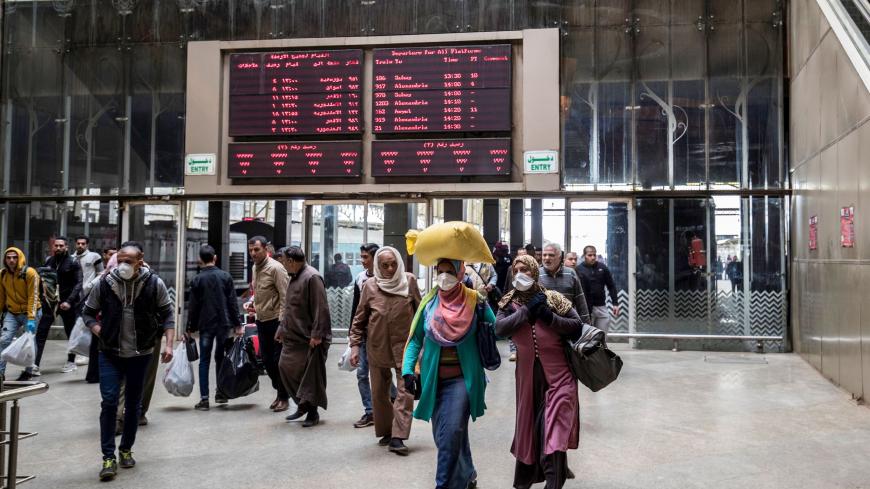 Passengers, some wearing face masks, arrive at Cairo's Ramses railway station in the Egyptian capital on March 20, 2020. (Photo by Khaled DESOUKI / AFP) (Photo by KHALED DESOUKI/AFP via Getty Images)