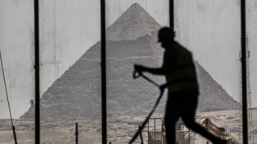 A picture taken on April 13, 2020, shows a view of the Great pyramid of Khafre (Chephren) seen through the scaffolding on the Grand Egyptian Museum (GEM), which is currently under construction, in Giza on the southwestern outskirts of the capital Cairo. (Photo by Khaled DESOUKI / AFP) (Photo by KHALED DESOUKI/AFP via Getty Images)