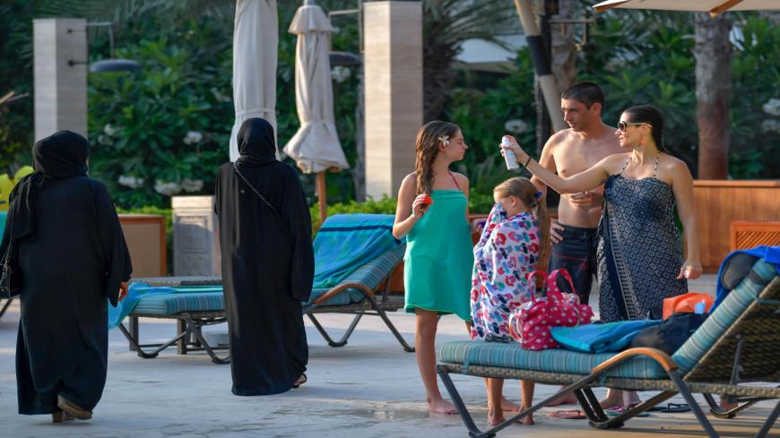 Tourists sunbathe by the pool of the Al Naseem hotel in the Gulf emirate of Dubai in the United Arab Emirates, on July 7, 2020. - With a "welcome" passport sticker and coronavirus tests on arrival, Dubai reopens its doors to international visitors in the hope of reviving its tourism industry after a nearly four-month closure. (Photo by KARIM SAHIB / AFP) (Photo by KARIM SAHIB/AFP via Getty Images)