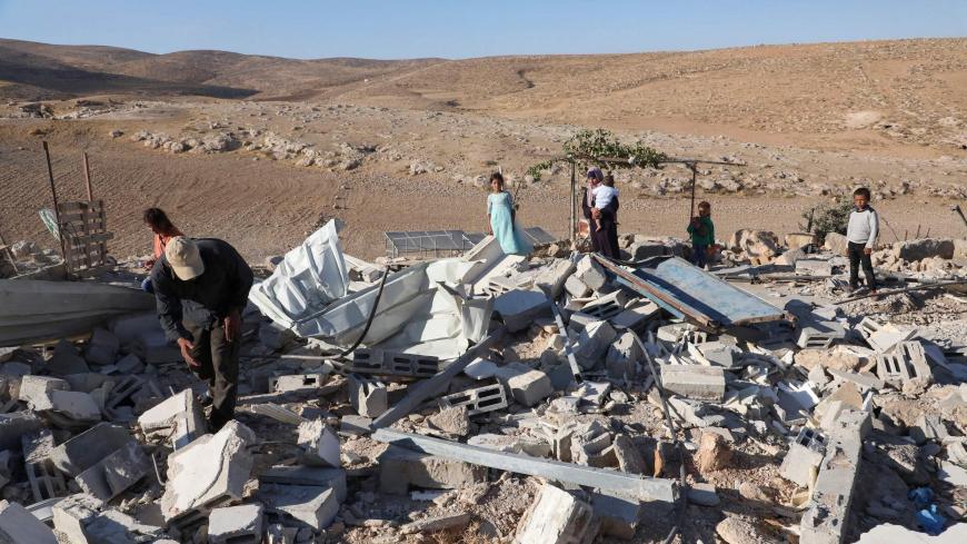 A Palestinian family whose house located in area C of the Israeli-occupied West Bank and was demolished by the military last month, is pictured at the ruins of their home, near the village of Yatta, south of Hebron, on August 10, 2020. - "Area C" is a stretch of land accounting for 60 percent of the West Bank over which Israel has control under the terms of the Oslo Accords signed between Israel and the Palestinians in the 1990s. It is extremely difficult for Palestinians to receive building permits from Is