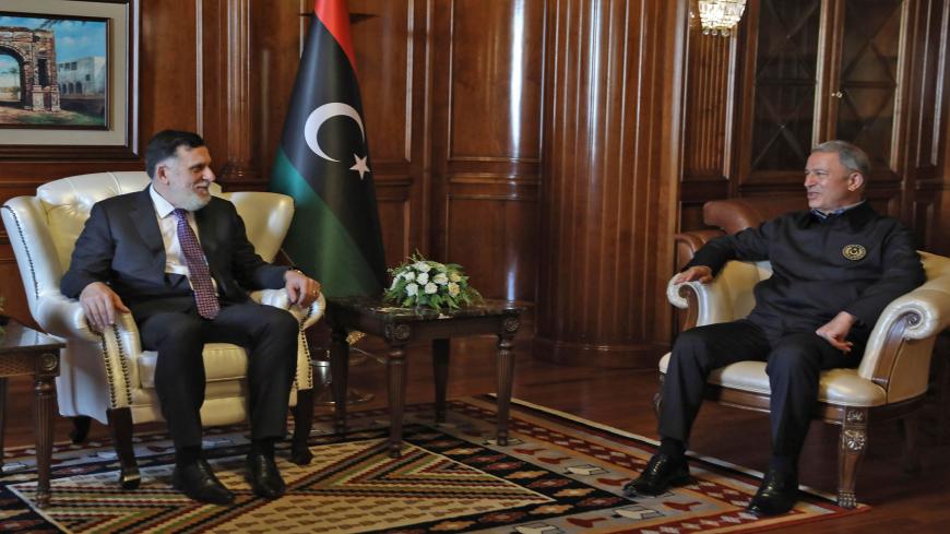Prime Minister of Libya's UN-recognised Government of National Accord (GNA) Fayez al-Sarraj (L) meets with Turkish Defence Minister Hulusi Akar in the capital Tripoli, on August 17, 2020. (Photo by - / AFP) (Photo by -/AFP via Getty Images)
