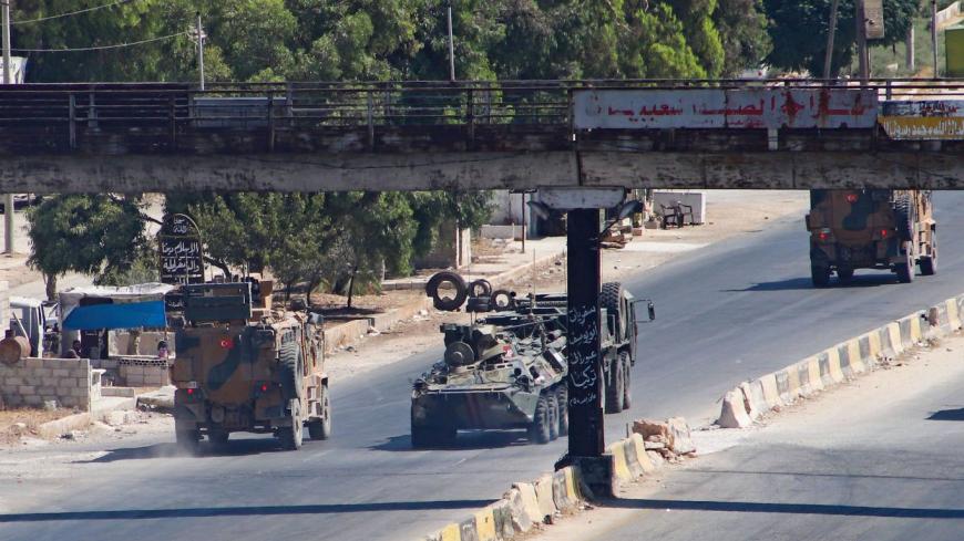 A Turkish-Russian military convoy tows a damaged vehicle after its joint patrol was reportedly targeted on the strategic M4 highway, near the Syrian town of Urum al-Jawz in the south of the northwestern Idlib province, on August 25, 2020. - Russia and Turkey launched joint patrols along the M4 highway in March following a ceasefire agreement aimed at stopping heavy fighting in and around Idlib, the last major bastion of anti-government forces in Syria's civil war. (Photo by Abdulaziz KETAZ / AFP) (Photo by 