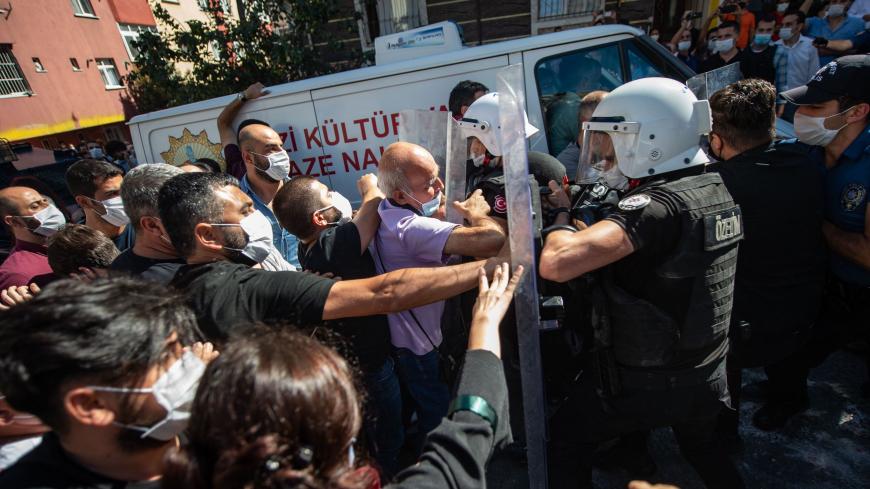 TOPSHOT - People clash with Turkish police ahead of the funeral of Turkish lawyer Ebru Timtik in the Gazi District of Istanbul on August 28, 2020. - A Turkish lawyer seeking a fair trial after being charged with membership of a terrorist organisation has died in an Istanbul hospital on the 238th day of her hunger strike.  Friends said Ebru Timtik weighed just 30 kilogrammes (65 pounds) at the time of her death late August 27, which has sparked condemnation from opposition parties in Turkey as well as from a