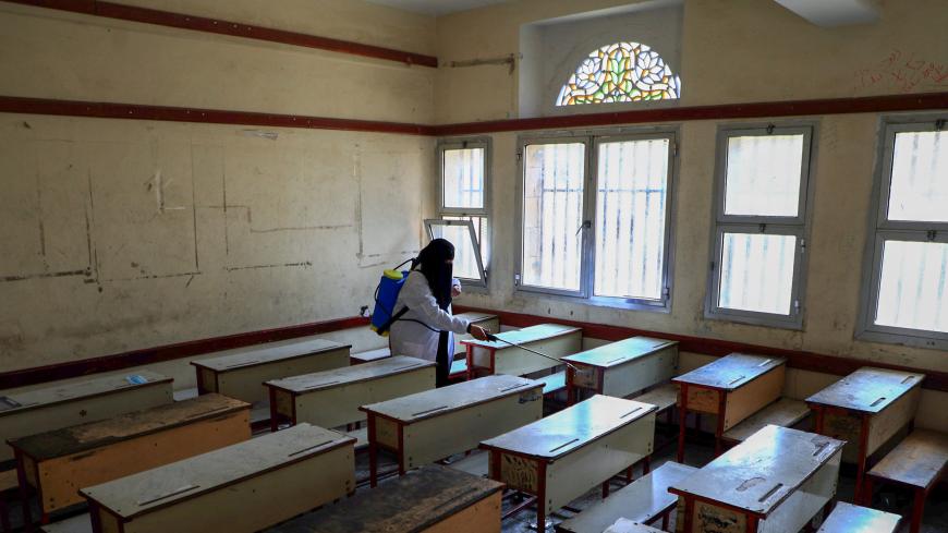 A Yemeni health worker sterilizes a classroom in a school amid the COVID-19 pandemic in the capital Sanaa, on August 29, 2020, ahead of the new school year starting in early September. (Photo by Mohammed HUWAIS / AFP) (Photo by MOHAMMED HUWAIS/AFP via Getty Images)