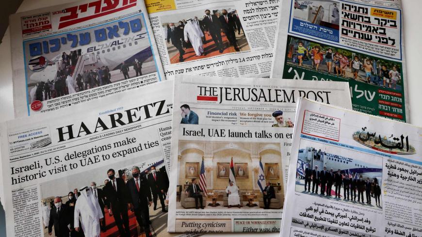 This picture taken on September 1, 2020 in Jerusalem shows the front pages of Israeli and Palestinian newspapers with images of the US-Israeli delegation arriving to Abu Dhabi on the first commercial flight from Tel Aviv to mark the normalisation of ties between the Jewish state and the UAE. (Photo by MENAHEM KAHANA / AFP) (Photo by MENAHEM KAHANA/AFP via Getty Images)