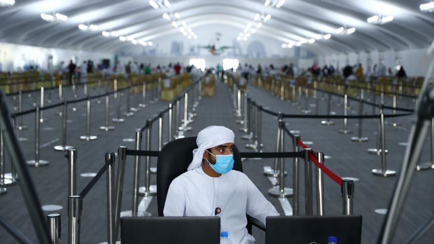 ABU DHABI, UNITED ARAB EMIRATES - AUGUST 10: A workers is seen at a testing center at the Dubai-Abu Dhabi border on August 10, 2020 in Abu Dhabi, United Arab Emirates. The UAE has recorded around 62,000 cases of covid-19, with 357 deaths, among its population of 9.6 million people. New cases have steadily declined since a spike at the beginning of July. (Photo by Francois Nel/Getty Images)