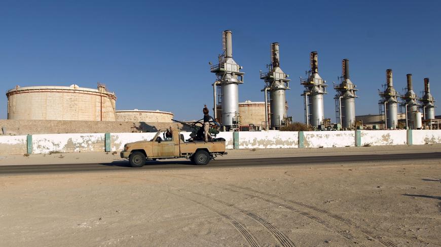 Forces opposed to Libya's unity government ride a truck in the Zueitina oil terminal on September 14, 2016.
Forces opposed to Libya's unity government handed management of four vital oil ports to the National Oil Company on September 14, after seizing them in a blow to fragile peace efforts. Prime minister-designate Fayez al-Sarraj called for urgent talks after the ports were captured by forces loyal to Field Marshal Khalifa Haftar, who supports a rival administration in the country's east.
 / AFP / Abdulla