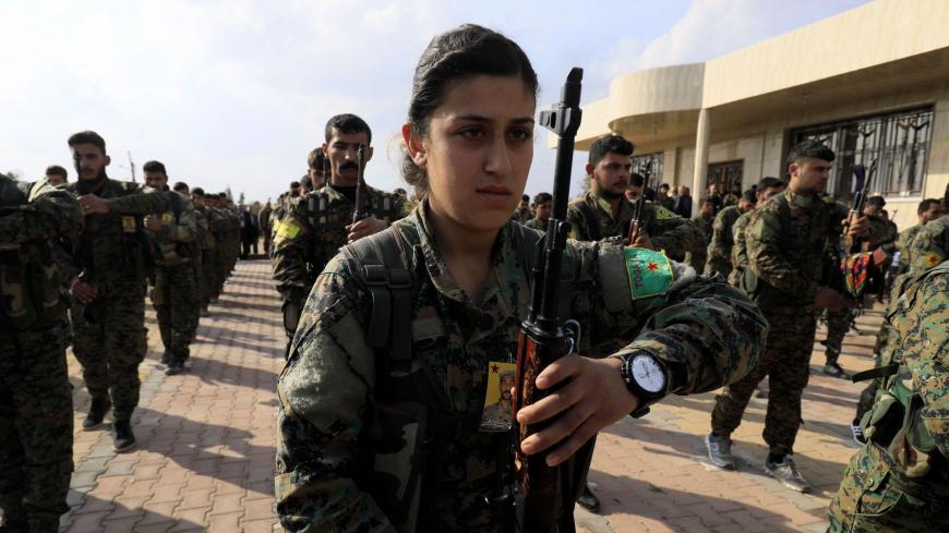 TOPSHOT - Members of the Kurdish People's Protection Units (YPG) and Women's Protection Units (YPJ) attend the funeral of Kurdish fighters from the Syrian Democratic Forces that were killed in combat against Islamic State (IS) group in Deir Ezzor, on March 3, 2018, in Qamishli. / AFP PHOTO / DELIL SOULEIMAN        (Photo credit should read DELIL SOULEIMAN/AFP via Getty Images)