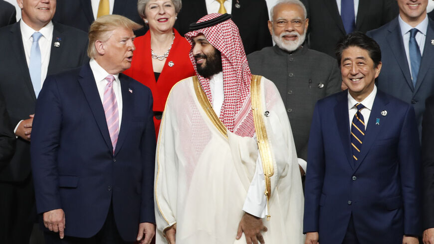 OSAKA, JAPAN - JUNE 28: U.S. President Donald Trump speaks with Saudi Arabia's Crown Prince Mohammed bin Salman during a family photo session at G20 summit on June 28, 2019 in Osaka, Japan. U.S. President Donald Trump arrived in Osaka on Thursday for the annual Group of 20 gathering together with other world leaders who will use the two-day summit to discuss pressing economic, climate change, as well as geopolitical issues. The US-China trade war is expected to dominate the meetings in Osaka as President Tr