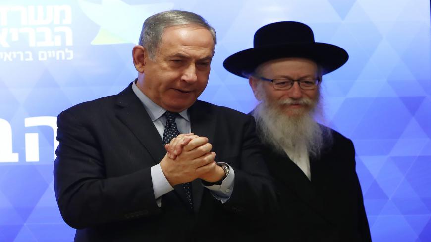 Israeli Prime Minister Benjamin Netanyahu (L) and Health Minister Yaakov Litzman give a joint press conference regarding preparations and new regulations for the coronavirus, at the Health Ministry in Jerusalem on March 4, 2020. (Photo by GALI TIBBON / AFP) (Photo by GALI TIBBON/AFP via Getty Images)