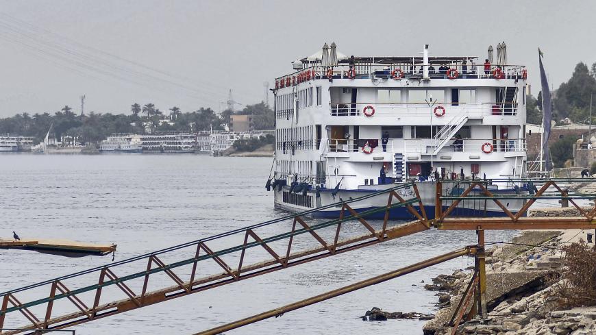 This picture taken on March 9, 2020 shows a view of the "A Sara" Nile cruise ship moored off the river bank of Egypt's southern city of Luxor, where 45 suspected COVID-19 coronavirus disease cases were detected and evacuated two days prior. - Egypt on March 8 reported the country's -- and Africa's -- first fatality from the virus, a 60-year-old German tourist who died in a Red Sea resort in eastern Egypt. The following day, Egypt's health ministry said the total number of known cases had risen to 55. Scores