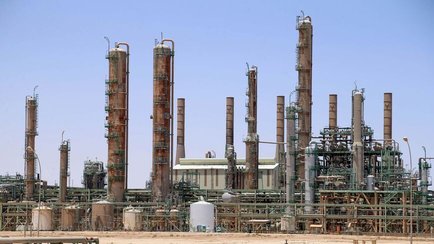 A picture taken on June 3, 2020 shows an oil refinery in Libya's northern town of Ras Lanuf. - Libya's National Oil Company said Monday it had restarted production at Al-Fil oil field, closed since January by the forces of eastern military strongman Khalifa Haftar. The NOC's announcement came a day after output resumed at Al-Sharara oil field, the country's largest, following a string of victories against Haftar by forces backing Libya's Tripoli-based unity government. (Photo by - / AFP) (Photo by -/AFP via