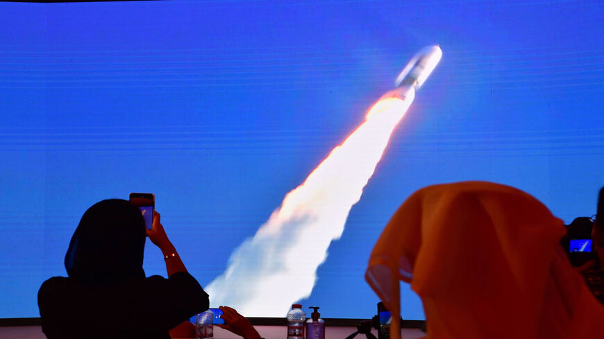 A picture taken on July 19, 2020, shows a screen broadcasting the launch of the "Hope" Mars probe at the Mohammed Bin Rashid Space Centre in Dubai. - The probe is one of three racing to the Red Planet, with Chinese and US rockets also taking advantage of the Earth and Mars being unusually close: a mere hop of 55 million kilometres (34 million miles). "Hope" -- Al-Amal in Arabic -- is expected to start orbiting Mars by February 2021, marking the 50th anniversary of the unification of the UAE. (Photo by Giuse
