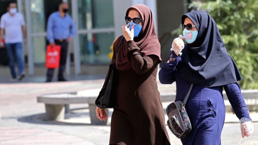 Iranian women, wearing protective masks due to the COVID-19 pandemic, shop in the capital Tehran on August 4, 2020. (Photo by ATTA KENARE / AFP) (Photo by ATTA KENARE/AFP via Getty Images)