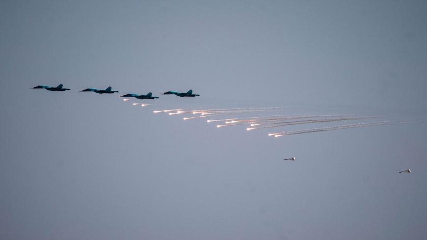 Russian fighter jets drop bombs over the Ashuluk military base in Southern Russia on September 22, 2020 during the "Caucasus-2020" military drills gathering China, Iran, Pakistan and Myanmar troops, along with ex-Soviet Armenia, Azerbaijan and Belarus. - Up to 250 tanks and around 450 infantry combat vehicles and armoured personnel carriers will take part in the September 21 to 26 land and naval exercises that will involve 80,000 people including support staff. (Photo by Dimitar DILKOFF / AFP) (Photo by DIM