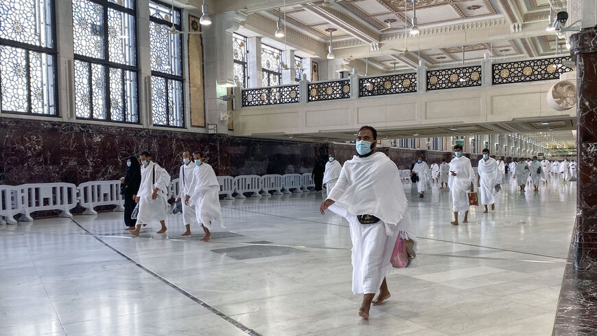Saudis and foreign residents walk down a hallway during Umrah in the Grand Mosque complex in the holy city of Mecca, on October 4, 2020, as authorities partially resume the year-round pilgrimage amid extensive health precautions after a seven-month coronavirus hiatus. (Photo by BANDAR AL-DANDANI / AFP) (Photo by BANDAR AL-DANDANI/AFP via Getty Images)