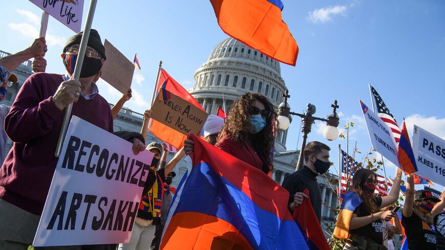 Armenian-Americans hold signs and flags as they protest against the conflict between Azerbaijan and the Armenian enclave of Nagorno-Karabakh and Turkey's support for Azerbaijan in front of the US Capitol in Washington, DC, on October 15, 2020. - US Secretary of State Mike Pompeo voiced hope Thursday that Armenia would "defend" itself against Azerbaijan, appearing to show sympathy to one side over the fierce clashes. (Photo by Nicholas Kamm / AFP) (Photo by NICHOLAS KAMM/AFP via Getty Images)