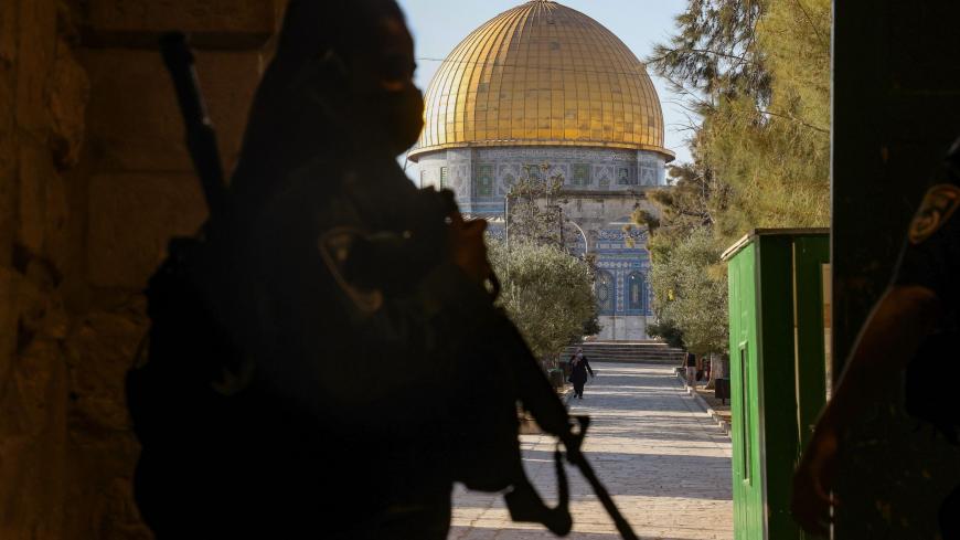 An Israeli policewoman stands guard at an entrance of the al-Aqsa compound, leading to the Dome of the Rock mosque in the Old City of Jerusalem on October 18, 2020, amid the novel coronavirus pandemic crisis. - Israel began to ease its month-long coronavirus nationwide lockdown, allowing citizens to venture further than 1km (0.6 miles) away from their home with preschools, daycare centres and places of worship reopening to all, under some restrictions. (Photo by Emmanuel DUNAND / AFP) (Photo by EMMANUEL DUN