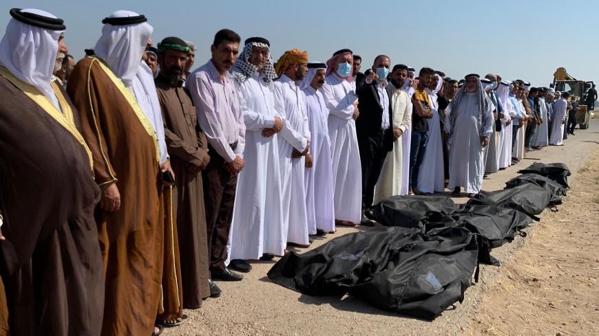 Sunni Muslim men pray over the bodies of eight out of 12 fellow Iraqis, who were reportedly kidnapped on October 17 and later some of them found shot dead, during their burial ceremony in the Farhatiya area of the Balad region, located 70 kilometres (around 45 miles) north of Baghdad in the Salaheddin province, on October 18, 2020. - Local sources said the four other kidnapped men have not been found and the identity of the assailants remains unknown in the mysterious crime. (Photo by - / AFP) (Photo by -/A