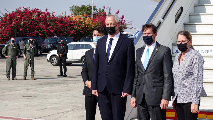 Benny Gantz (C), Israel's Alternate Prime Minister and Defence Minister, receives US Defense Secretary Mark Esper (2nd-R) and his wife Leah (R), all mask-clad due to the COVID-19 coronavirus pandemic, at Ben Gurion International Airport in Lod on October 29, 2020. (Photo by Paul HANDLEY / AFP) (Photo by PAUL HANDLEY/AFP via Getty Images)
