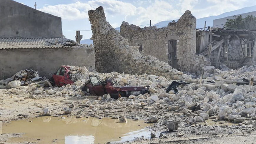 This picture shows destroyed car and collapsed buildings after an earthquake in the island of Samos on October 30, 2020. - A powerful earthquake hit Greece and Turkey on October 30, 2020, causing buildings to collapse and a sea surge that flooded streets in the Turkish resort city of Izmir. Greek public television said the quake also caused a mini-tsunami on the eastern Aegean Sea island of Samos, damaging buildings. The US Geological Survey said the 7.0 magnitude quake was registered 14 kilometres (8.6 mil