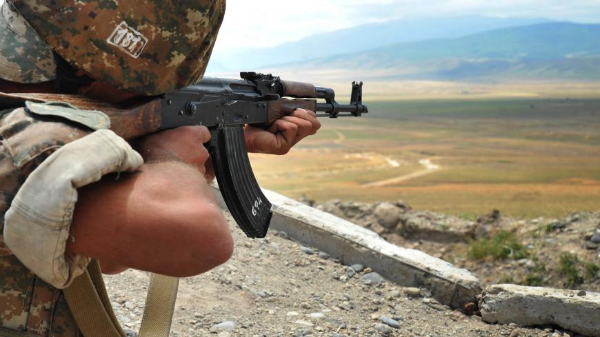 An Armenian soldier of the self-proclaimed republic of Nagorno-Karabagh aims his Kalashnikov assault rifle as he stands in a trench at the frontline on the border with Azerbaijan near the town of Martakert, on July 6, 2012. EU president Herman Van Rompuy urged last week enemies Armenia and Azerbaijan to end frontline clashes that have raised fears of renewed war over the disputed region of Nagorny Karabakh. Armenia-backed separatists seized Karabakh from Azerbaijan in a war in the 1990s that left some 30,00