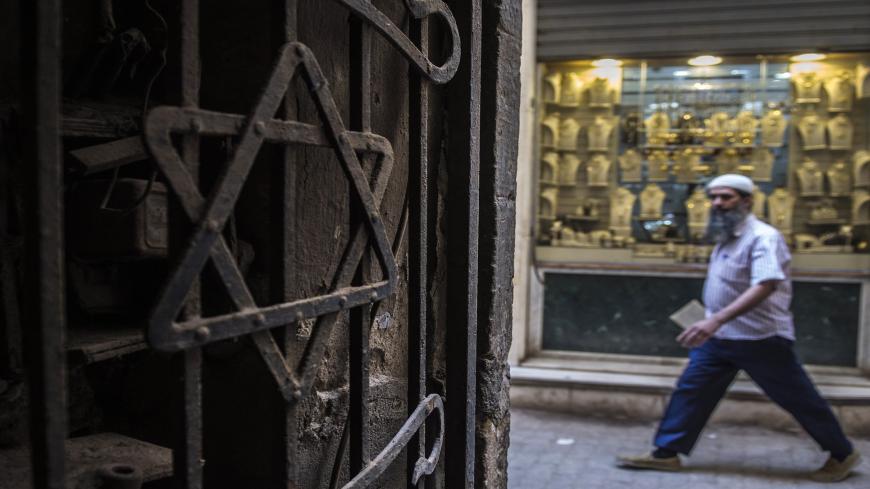 A man walks past a Star of David decorating the door of a home in the Jewish quarter of the Egyptian capital, Cairo, on June 25, 2015. An Egyptian soap opera titled "The Jewish Quarter" aiming to dispel prejudice towards the country's long-vilified and nearly extinct Jewish community is being aired during the holy Muslim fasting month of Ramadan. AFP PHOTO / KHALED DESOUKI        (Photo credit should read KHALED DESOUKI/AFP via Getty Images)