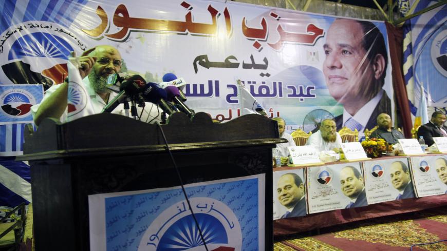 Members of the Islamist al-Nuor party hold a public conference in support of ex-army chief and presidential candidate Abdel-Fattah Al-Sisi (portrait) in Egypt's northern port city of Alexandria on May 20, 2014. Egypt's Salafist party al-Nour is securing its place on the political scene but loosing supporters by backing Sisi who has launched a crackdown on their former Islamist allies the Muslim Brotherhood. AFP PHOTO / AHMED ARAB / AFP PHOTO / -        (Photo credit should read -/AFP via Getty Images)
