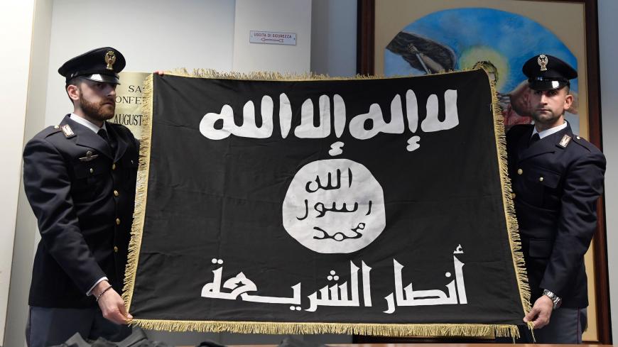 Italian police displayed a confiscated Islamic State (IS) during a press conference on anti-terrorism operation at the police headquarters in Rome.
Hmidi Saber, a suspected member of Ansar al-Sharia, a Libyan group linked to al-Qaeda, was arrested on January 10, 2017 in an anti-terrorism operation called 'Black Flag'. / AFP / TIZIANA FABI        (Photo credit should read TIZIANA FABI/AFP via Getty Images)